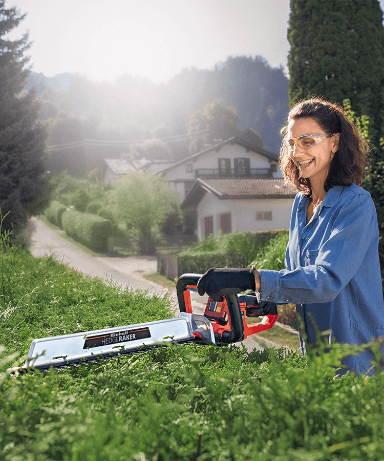 woman trimming hedge