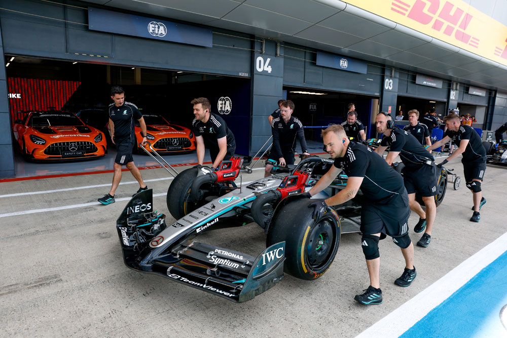 Formula 1 car getting pushed.